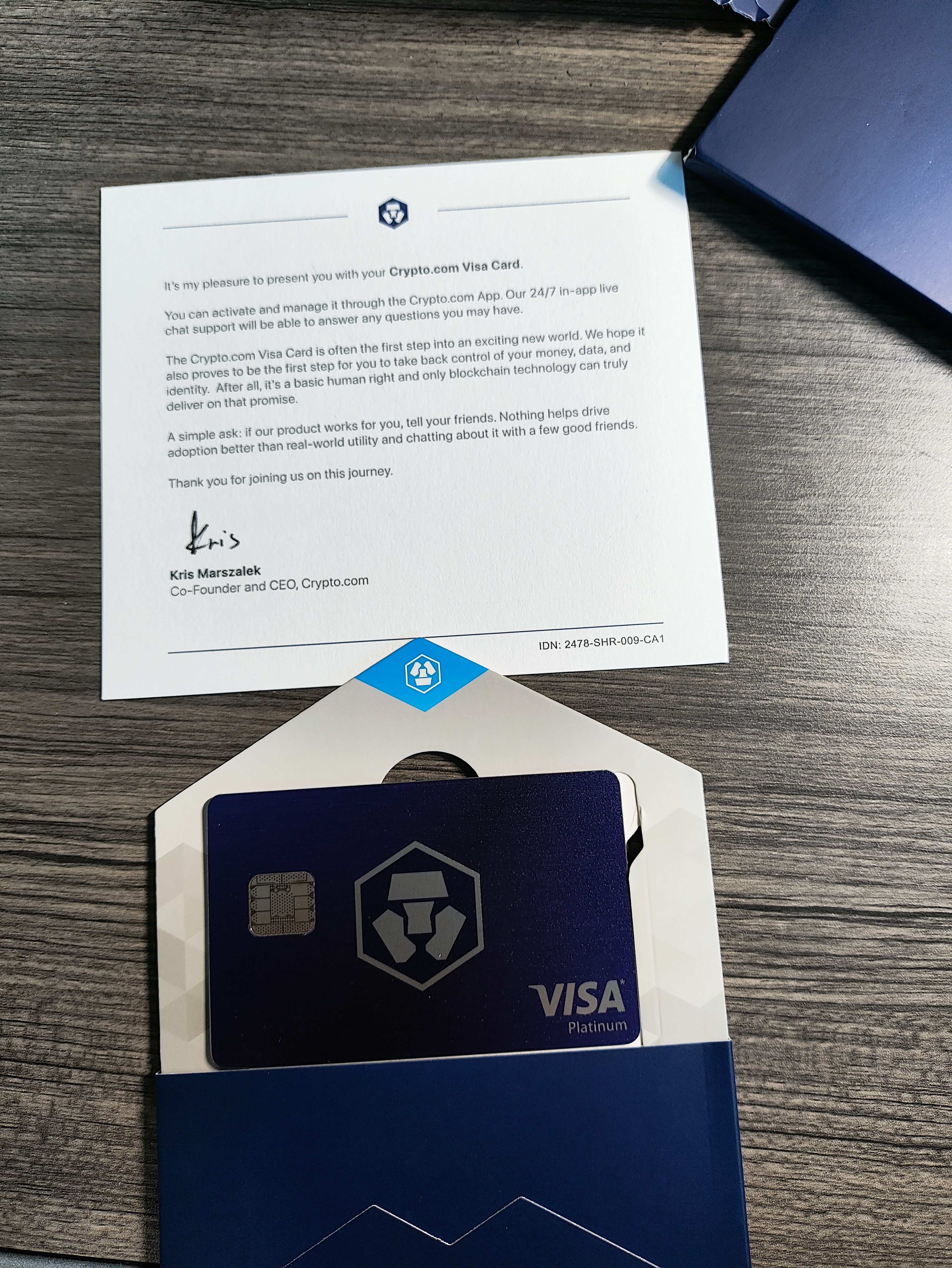 The metal Crypto.com Visa card, fresh out of the box with a welcome note from the CEO